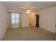 Bright living room with neutral carpeting and large window at 870 Regatta Bay Dr # 4-103, Orange City, FL 32763