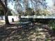 Community picnic table under shade trees at 870 Regatta Bay Dr # 4-103, Orange City, FL 32763