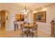 Bright breakfast nook with a round table and chairs, offering a view of the kitchen at 8755 The Esplanade # 103, Orlando, FL 32836