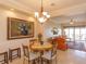 Cozy breakfast nook with a round table and chairs, offering a view of the living room at 8755 The Esplanade # 103, Orlando, FL 32836