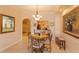 Bright breakfast nook with a round table and chairs, offering a view of the kitchen at 8755 The Esplanade # 103, Orlando, FL 32836