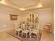Formal dining room with glass-top table and antique china cabinet at 8755 The Esplanade # 103, Orlando, FL 32836