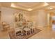 Formal dining room with glass-top table and antique china cabinet at 8755 The Esplanade # 103, Orlando, FL 32836