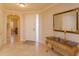 Elegant entryway with a marble-top console table and mirror at 8755 The Esplanade # 103, Orlando, FL 32836