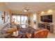 Spacious living room with hardwood floors, large windows, and comfortable seating at 8755 The Esplanade # 103, Orlando, FL 32836