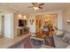 Bright living room features hardwood floors, ample seating and a view into the dining area at 8755 The Esplanade # 103, Orlando, FL 32836