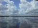 Stunning water view with clouds reflecting on the lake at 8755 The Esplanade # 103, Orlando, FL 32836