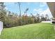 Large grassy backyard, partially fenced, with mature trees providing shade at 936 Jetway Street, Orange City, FL 32763