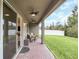 Relaxing covered patio with pavers, wicker furniture, and a fenced-in yard at 936 Jetway Street, Orange City, FL 32763