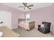 Charming bedroom with pink walls, twin bed, and comfy chair at 936 Jetway Street, Orange City, FL 32763