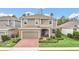 Two-story home with neutral siding, brick paver driveway, and landscaping at 936 Jetway Street, Orange City, FL 32763