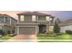 Two-story home with neutral siding, brick paver driveway, and landscaping at 936 Jetway Street, Orange City, FL 32763