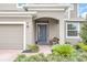 Front entry with gray door, brick walkway, and landscaping at 936 Jetway Street, Orange City, FL 32763