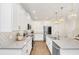 Modern kitchen with white cabinets, stainless steel appliances, and gray countertops at 936 Jetway Street, Orange City, FL 32763