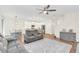 Open concept living room features hardwood floors and a view of the kitchen and dining area at 936 Jetway Street, Orange City, FL 32763