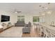 Open living space with gray sectional sofa, hardwood floors, and large windows at 936 Jetway Street, Orange City, FL 32763