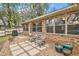 Brick patio with seating and a view of the backyard at 9908 Fairway Cir, Leesburg, FL 34788