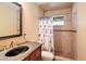 Bathroom with single vanity, dark countertop and shower/tub combo at 9908 Fairway Cir, Leesburg, FL 34788