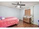 Bedroom with a full-size bed, dresser, and ceiling fan at 9908 Fairway Cir, Leesburg, FL 34788