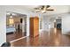 Bright bonus room with hardwood floors, ceiling fan, and views into other rooms at 9908 Fairway Cir, Leesburg, FL 34788
