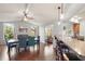 Open dining area with hardwood floors and fireplace at 9908 Fairway Cir, Leesburg, FL 34788