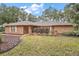 Brick ranch house with landscaped yard and shed at 9908 Fairway Cir, Leesburg, FL 34788