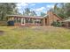 Brick house with large windows and grassy backyard at 9908 Fairway Cir, Leesburg, FL 34788