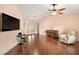Living room with hardwood floors, vaulted ceiling, and views to kitchen at 9908 Fairway Cir, Leesburg, FL 34788