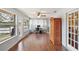 Bright sunroom with hardwood floors and French doors at 9908 Fairway Cir, Leesburg, FL 34788