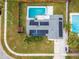 Aerial shot of a home highlighting solar panels, a fenced yard, and proximity to a refreshing in-ground swimming pool at 102 Aberdeen Dr, Fern Park, FL 32730