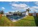 Backyard view of the fenced swimming pool and patio, surrounded by a well-maintained lawn and the house at 102 Aberdeen Dr, Fern Park, FL 32730