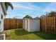 Backyard with a storage shed and wood fencing, enclosed grassy area at 102 Aberdeen Dr, Fern Park, FL 32730