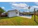 Exterior view of the backyard with a fenced in pool, patio, grassy area, and the back of the house at 102 Aberdeen Dr, Fern Park, FL 32730