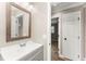 Bathroom with a gray vanity, a white countertop, decorative mirror, and doorway to bedroom at 102 Aberdeen Dr, Fern Park, FL 32730