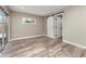 Bedroom with wood-look floors, barn door, and natural light from sliding glass doors at 102 Aberdeen Dr, Fern Park, FL 32730