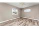 This bedroom features wood-look tile, fan and great natural light from the two windows at 102 Aberdeen Dr, Fern Park, FL 32730