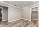 Well-lit bedroom featuring wood-look tile floors and a walk in closet at 102 Aberdeen Dr, Fern Park, FL 32730