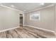 Bright bedroom with wood-look tile floors, ample natural light, and a spacious closet at 102 Aberdeen Dr, Fern Park, FL 32730