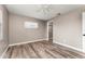 Bedroom featuring wood-look tile, fan and an open closet offering ample storage at 102 Aberdeen Dr, Fern Park, FL 32730