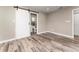 Bedroom showcases wood-look floors, barn door leading to an ensuite bathroom with a toilet and vanity at 102 Aberdeen Dr, Fern Park, FL 32730