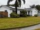 House exterior showcasing solar panels and a grassy lawn at 102 Aberdeen Dr, Fern Park, FL 32730