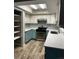 Modern kitchen with teal cabinets and quartz countertops at 102 Aberdeen Dr, Fern Park, FL 32730