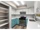 Bright kitchen boasts stainless steel range, ample storage, and white and blue cabinetry at 102 Aberdeen Dr, Fern Park, FL 32730