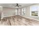 Inviting living room showcasing stylish wood-look flooring, neutral wall tones, and bright natural lighting at 102 Aberdeen Dr, Fern Park, FL 32730