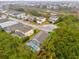 Aerial view of house and neighborhood with pool and lush trees at 1037 Balmoral Dr, Davenport, FL 33896