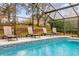 Enclosed pool area with lounge chairs and a view at 1037 Balmoral Dr, Davenport, FL 33896