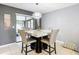 Casual dining area with marble table and four chairs, near a pet bed at 1113 Matterhorn Street, Deltona, FL 32725