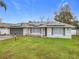 Single-story house with solar panels, gray accents, and green lawn at 1113 Matterhorn Street, Deltona, FL 32725