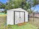 White metal storage shed with double doors at 1113 Matterhorn Street, Deltona, FL 32725