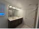 Double vanity bathroom with a large mirror and shower at 1200 Happy Forest Loop, Deland, FL 32720